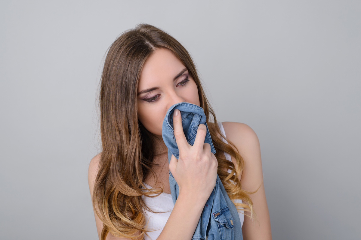 Shutterstock 1124446469 Woman Smelling Man's Shirt